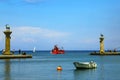 Rhodes, Greece. Red walking tourist underwater, the boat swims into the gates of the famous port of Rhodes with